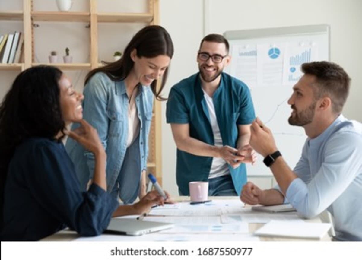 Nl_smiling-diverse-colleagues-gather-boardroom_1200_862
