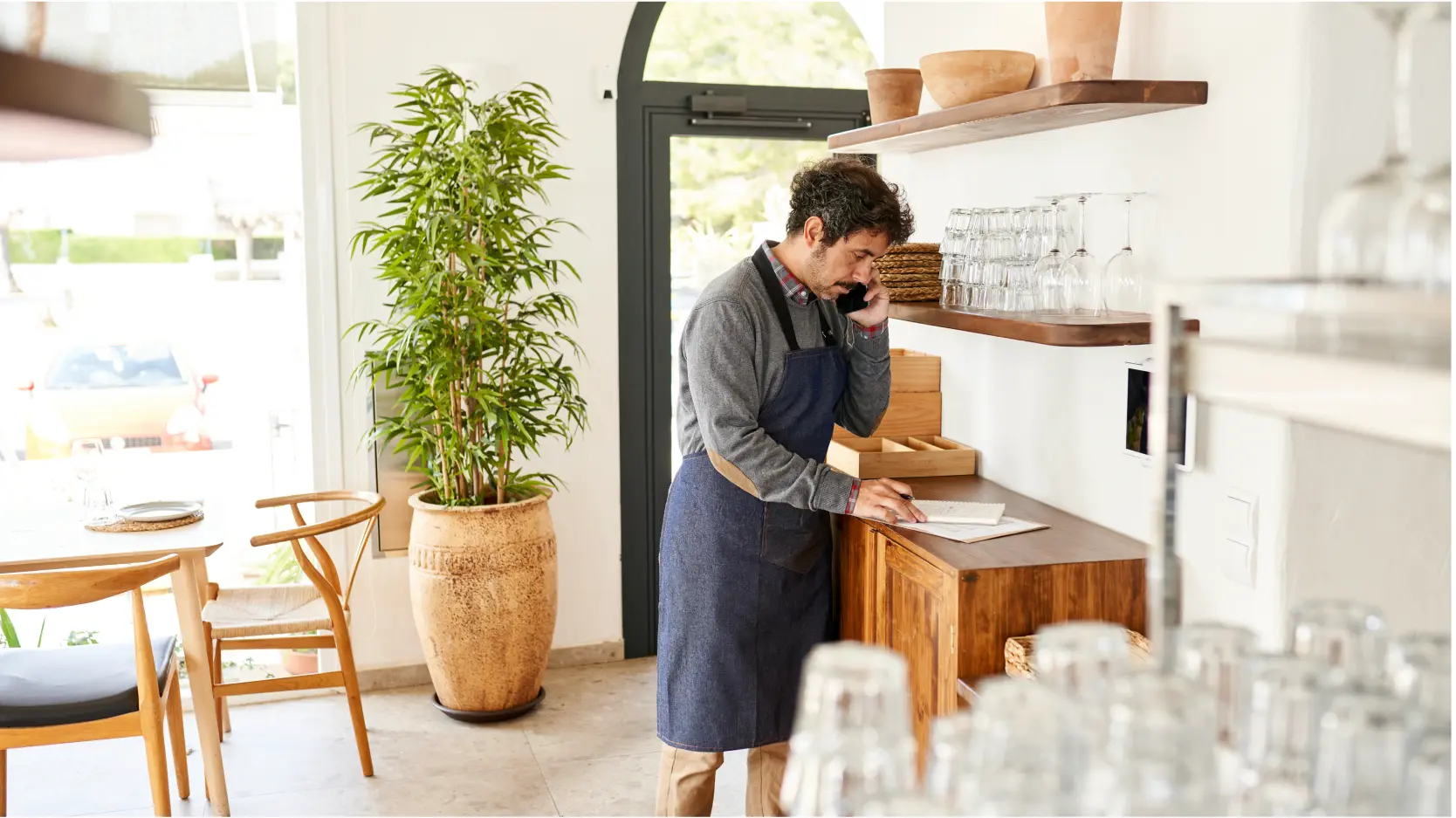 Small business owner in cafe working on payroll